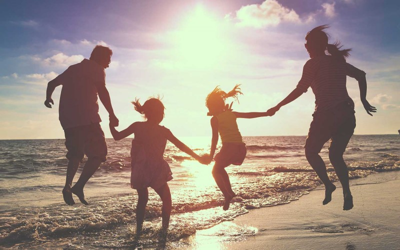 Family on the beach with Travel Perks